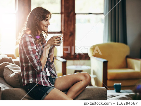 Coffee, relax and thinking with woman on sofa in living room of home for morning or weekend time off. Drink, happy or smile and person in apartment with fresh caffeine beverage for break or wellness 116294567