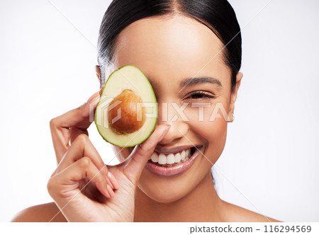 Portrait, avocado and woman with smile in studio for skincare, wellness and nutrition. Model girl, glow and vitamin c for vegan and organic products for health and detox by white background. 116294569