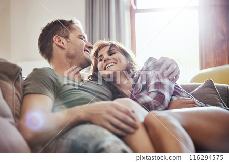 Happy, couple and hug on sofa with laughing at home for funny joke, humor and romance in relationship. Peace, man and woman with smile in living room for joy, comfort and bonding together on weekend Happy, couple and hug on sofa with laughing at home for funny joke, humor and romance in relationship. Peace, man and woman with smile in living room for joy, comfort and bonding together on weekend 116294575