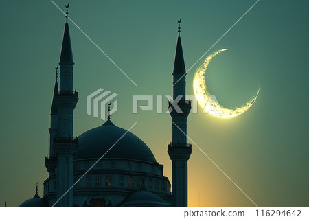 A Crescent Moon Illuminates the Silhouetted Minarets of a Mosque at Dusk A Crescent Moon Illuminates the Silhouetted Minarets of a Mosque at Dusk 116294642