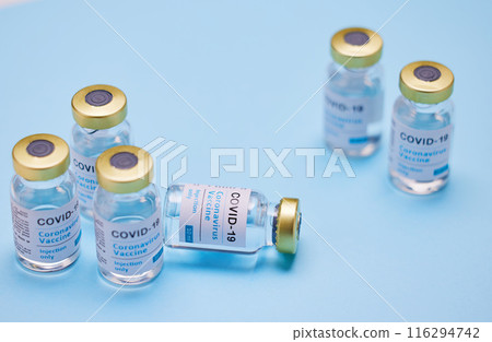Medical, Covid vaccine and bottle in studio, innovation in health care for pandemic. Blue background, glass container and medicine with research for virus, chemistry development for human wellness Medical, Covid vaccine and bottle in studio, innovation in health care for pandemic. Blue background, glass container and medicine with research for virus, chemistry development for human wellness 116294742