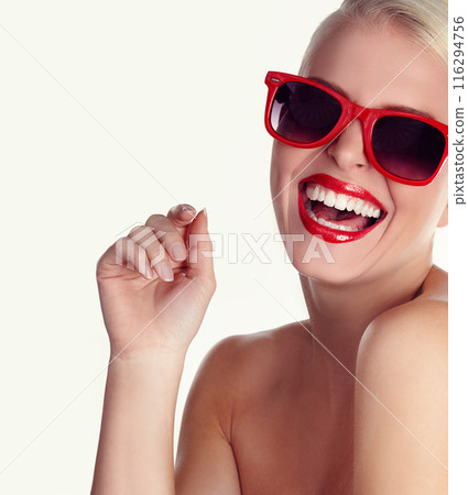 Lipstick, woman and sunglasses for style in studio with makeup and smile for summer. Happy, model girl and eyewear for cosmetics, fashion and aesthetics by white background for retro or art deco 116294756