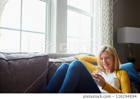 Happy, reading and woman on couch, phone and rest in living room, morning and social media in house. Relax, calm and girl with mobile, smile or peace in lounge, cozy and person with chat in apartment Happy, reading and woman on couch, phone and rest in living room, morning and social media in house. Relax, calm and girl with mobile, smile or peace in lounge, cozy and person with chat in apartment 116294894