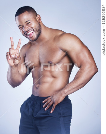 Body, fitness and black man portrait with peace hands in studio for thank you, cool or support on grey background. V, emoji and face of African bodybuilder with sixpack, goal and training motivation Body, fitness and black man portrait with peace hands in studio for thank you, cool or support on grey background. V, emoji and face of African bodybuilder with sixpack, goal and training motivation 116295084