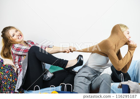 Two women arguing over sweater Two women arguing over sweater 116295187
