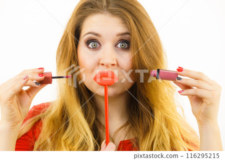 Woman applying lipstick or lip gloss Woman applying lipstick or lip gloss 116295215