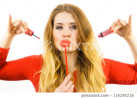Woman applying lipstick or lip gloss 116295216