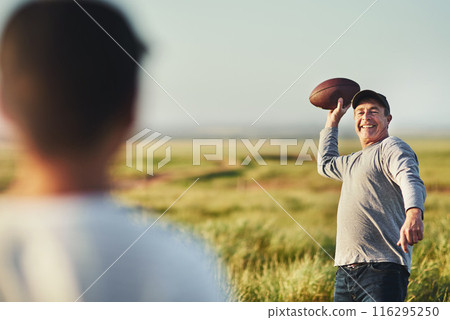 Son, man and football with teaching in nature for outdoor sports, child development and practice together. Smile, dad and throw with kid on grass field for exercise, bonding and fathers day in Texas Son, man and football with teaching in nature for outdoor sports, child development and practice together. Smile, dad and throw with kid on grass field for exercise, bonding and fathers day in Texas 116295250