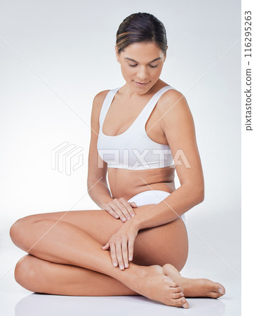 Woman, underwear and legs smooth for cosmetics, skincare and epilation in white studio background. Female person, wax or clean shave touching for health, wellness and hygiene or hair removal Woman, underwear and legs smooth for cosmetics, skincare and epilation in white studio background. Female person, wax or clean shave touching for health, wellness and hygiene or hair removal 116295263