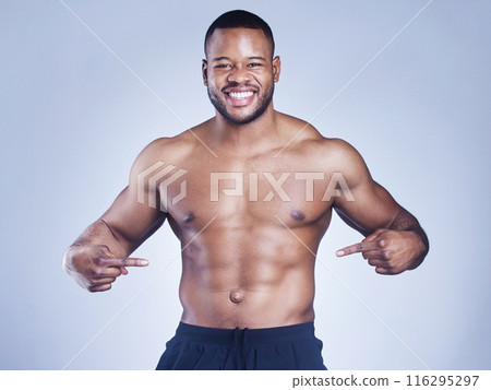 Fitness, portrait and black man with hand pointing to stomach in studio for training, wellness and abs progress on grey background. Sports, face and happy athlete show sixpack, growth and muscle flex Fitness, portrait and black man with hand pointing to stomach in studio for training, wellness and abs progress on grey background. Sports, face and happy athlete show sixpack, growth and muscle flex 116295297