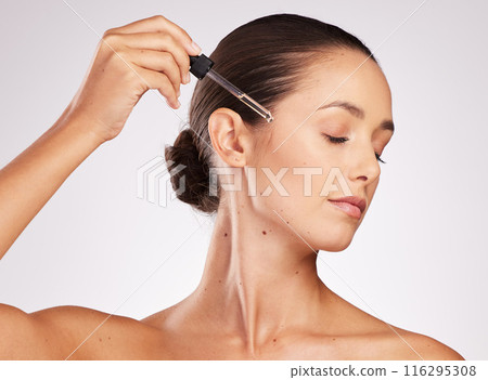 Woman, dropper and beauty with serum for skincare results, natural glow and application for skin health in studio. Model girl, dermatology and facial oil for cosmetics or collagen by white background Woman, dropper and beauty with serum for skincare results, natural glow and application for skin health in studio. Model girl, dermatology and facial oil for cosmetics or collagen by white background 116295308