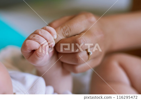 Baby, hand and holding fingers with woman in house, wellness and security together for family bonding with newborn. Bedroom, motherhood and relax with infant for care, childhood and growth with love 116295472