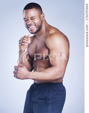 Black man, portrait and shirtless boxer in studio, strong arms and muscle on blue background. Male person, confident and athlete fighter for power or healthy body, bodybuilder and topless for fitness 116295664