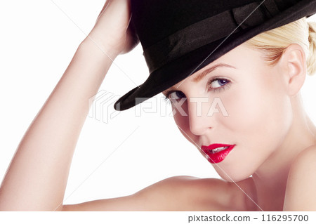Lipstick, hat and portrait of woman in studio for fashion, style and designer clothing on white background. Glamour, elegance and mysterious person with cosmetics for luxury, beauty and confidence 116295700