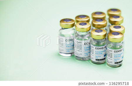 Medical, Covid vaccine and bottle in studio, innovation in health care for pandemic. Green background, glass container and medicine with research for virus, chemistry development for human wellness 116295718