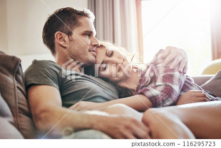 Couple, relax and home in lounge, love and cozy in marriage, embrace and peace in break and morning. House, man and woman on sofa, together and rest in living room, bonding and smile for relationship 116295723