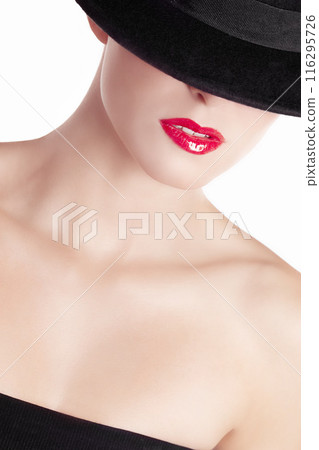 Red lipstick, hat and face of woman in studio for fashion, style and designer clothing on white background. Glamour, elegance and mysterious person with cosmetics for luxury, beauty and confidence 116295726