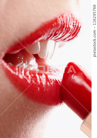 Woman, beauty and red for lipstick in studio, makeup and cosmetics for care on white background. Female person, salon and skincare in closeup, grooming and application in makeover or skin treatment Woman, beauty and red for lipstick in studio, makeup and cosmetics for care on white background. Female person, salon and skincare in closeup, grooming and application in makeover or skin treatment 116295766