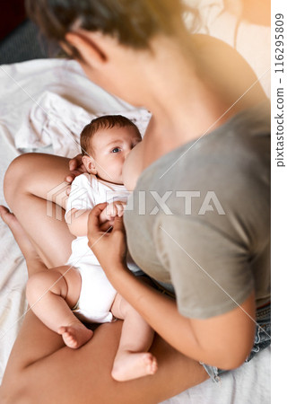 Mom, baby and breastfeeding on bed for development growth, nutrition or digestive health in bedroom . Lens flare, top view and woman with newborn child for natural milk, wellness or bonding in home Mom, baby and breastfeeding on bed for development growth, nutrition or digestive health in bedroom . Lens flare, top view and woman with newborn child for natural milk, wellness or bonding in home 116295809