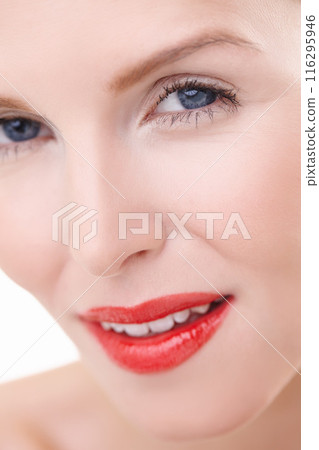 Woman, portrait and smile with red lipstick for beauty with makeup, mascara and cosmetics treatment in studio. Closeup, happy and dermatology with lip product, cosmetology and skincare for self care 116295946