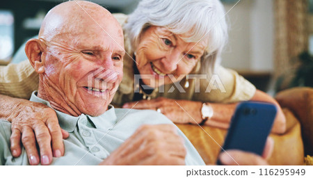 Senior couple, phone and reading on couch with hug, choice and click with video, download or search in home. Elderly woman, man and smartphone on lounge sofa with discussion for post on social media Senior couple, phone and reading on couch with hug, choice and click with video, download or search in home. Elderly woman, man and smartphone on lounge sofa with discussion for post on social media 116295949