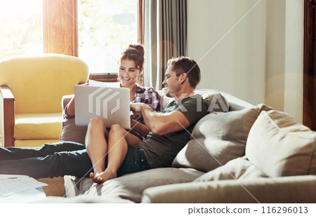 Happy couple, laptop and talking on sofa for budget, planning and savings account for personal debt. Man, woman and together on couch with computer for expenses, tax and loan payment in living room Happy couple, laptop and talking on sofa for budget, planning and savings account for personal debt. Man, woman and together on couch with computer for expenses, tax and loan payment in living room 116296013