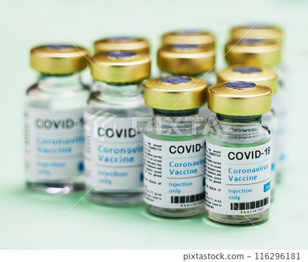 Medical, Covid vaccine and bottle in studio, innovation in health care for pandemic. Green background, glass container and medicine with research for virus, chemistry development for human wellness Medical, Covid vaccine and bottle in studio, innovation in health care for pandemic. Green background, glass container and medicine with research for virus, chemistry development for human wellness 116296181