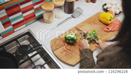 Cooking, chopping and hands with vegetables, kitchen and knife on wooden board, food and breakfast. Morning, wellness and healthy for person, home and diet for vegan, countertop and meal prep Cooking, chopping and hands with vegetables, kitchen and knife on wooden board, food and breakfast. Morning, wellness and healthy for person, home and diet for vegan, countertop and meal prep 116296226