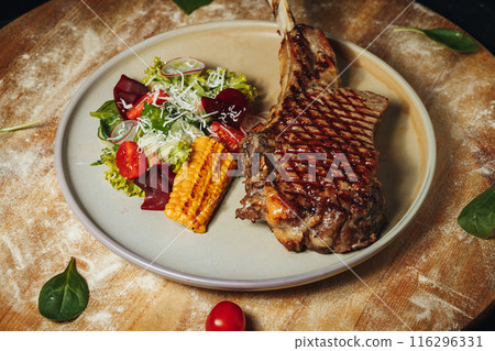 A Savory Feast,A plate with a succulent steak cooked to perfection  116296331
