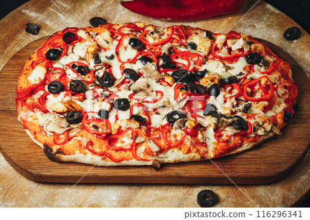 Artisanal Pizza With Olives and Peppers on Wooden Cutting Board 116296341