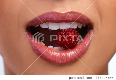 Woman, teeth and mouth with lipstick and raspberry for dental care, hygiene and oral health. Model girl, cosmetics and fruit for smile in studio with glow, wellness and vegan for diet or results 116296366