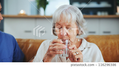 Senior woman, nurse and glass for drinking water on sofa with thirst, medicine and wellness in living room. People, caregiver and elderly patient with health, detox and gut health on couch in house 116296386