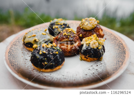 A plate displaying a diverse assortment of freshly baked pastries, 116296524