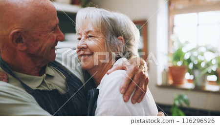 Senior couple, hug and happy in kitchen with love, support and bonding for health, wellness and nutrition. Elderly man and woman embrace for cooking and marriage at home for romance or anniversary 116296526