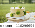 Sunshine Blossom Cake,A luscious yellow cake adorned with vibrant green flowers on top 116296654