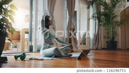 Woman, living room and stretching with tablet for yoga or online class, personal blog and content creation for internet. Girl, pose and calm in home for peace or mindset, exercise and mental health. Woman, living room and stretching with tablet for yoga or online class, personal blog and content creation for internet. Girl, pose and calm in home for peace or mindset, exercise and mental health. 116296751