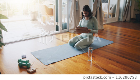 Girl, living room and online with tablet for yoga or virtual class, personal blog and content creation for internet. Woman, pose and calm in home for peace or mindset, exercise and mental health. 116296758