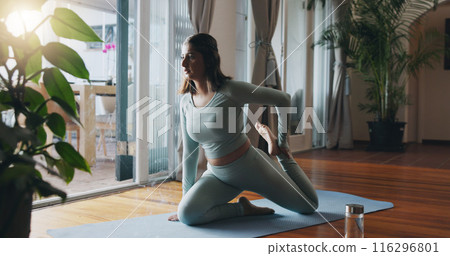 Yoga, stretch and woman in home for workout, healthy body and mindfulness with incense. Morning, mental health and person in house for pilates exercise, mobility or wellness for calm in living room 116296801