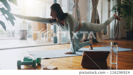 Girl, living room and stretching with tablet for yoga or online class, personal blog and content creation for internet. Woman, pose and calm in home for peace or mindset, exercise and mental health. Girl, living room and stretching with tablet for yoga or online class, personal blog and content creation for internet. Woman, pose and calm in home for peace or mindset, exercise and mental health. 116296924