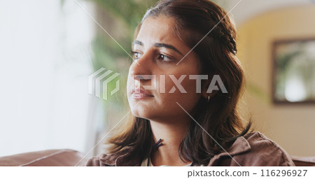 Mental health, thinking and girl with depression, sad and unhappy on sofa in living room, house and home. Anxiety, emotional and concerned woman with stress, moody and miserable person on couch 116296927