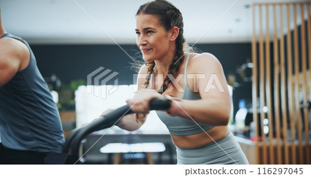 Fitness, bike machine and girl in gym for training, workout and cardiovascular endurance. Health club, cyclist and female athlete on bicycle equipment for exercise, calorie burning or muscle strength 116297045
