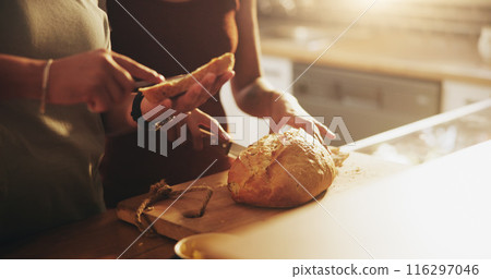 Kitchen, home and hands of people with bread on counter with slice for sandwich, breakfast and meal. Food, morning and couple with butter on roll or baked loaf for wellness, eating and carbohydrates 116297046