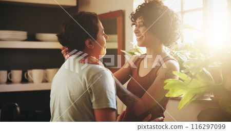 Couple, lesbian women and hug with smile in kitchen, sunshine or bonding with connection in morning at house. People, partner and happy for embrace with care, love and lgbtq relationship in apartment 116297099