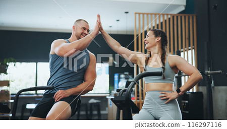 High five, fitness bike or people in gym for training, workout or cardiovascular endurance. Health, happy friends or celebration with hand gesture on bicycle for exercise, calorie burning or teamwork High five, fitness bike or people in gym for training, workout or cardiovascular endurance. Health, happy friends or celebration with hand gesture on bicycle for exercise, calorie burning or teamwork 116297116