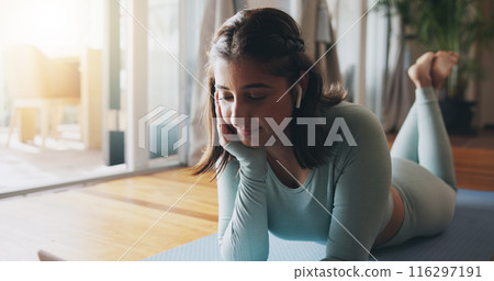 Wellness, woman and earbuds for music in yoga, decision and browsing for start in living room. Thinking, calm and girl with technology for exercise, wellbeing and rest on mat for meditation or zen Wellness, woman and earbuds for music in yoga, decision and browsing for start in living room. Thinking, calm and girl with technology for exercise, wellbeing and rest on mat for meditation or zen 116297191