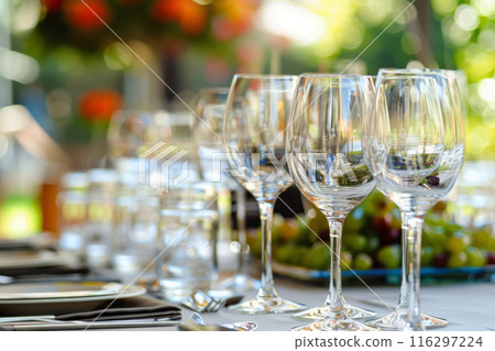 Beautifully arranged table featuring fresh fruits, champagne glasses, and a variety of gourmet snacks 116297224