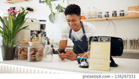 Man, cafe and barista with smile at phone for ecommerce, networking and communication at counter. Male person, small business and waiter with technology for online sale, funny discussion and service 116297331