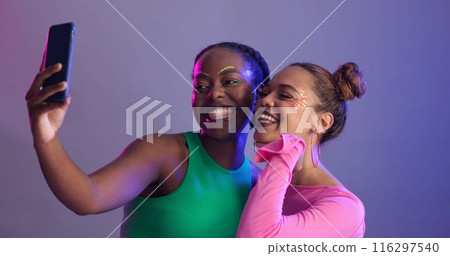 Makeup, women and friends with fashion, selfie and gen z with stylish clothes on studio background. People, models or girls with cellphone, beauty and connection for memory, profile picture or trendy Makeup, women and friends with fashion, selfie and gen z with stylish clothes on studio background. People, models or girls with cellphone, beauty and connection for memory, profile picture or trendy 116297540