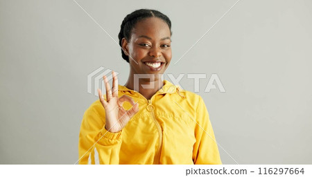 Portrait, black woman and OK sign with smile, success and approval on grey studio background. African person, face or model with hand gesture, like and emoji with icon, yes or agreement with feedback 116297664