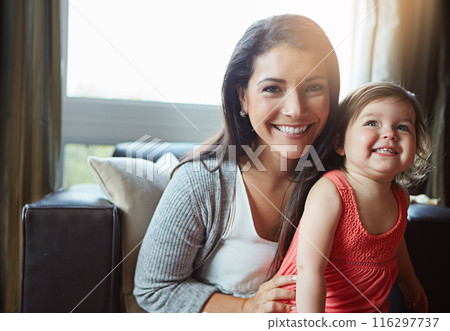 Portrait, mother and girl child on sofa with smile for bonding, connection and development in home together. Happy, woman and daughter on couch with love for relationship, support and community 116297737